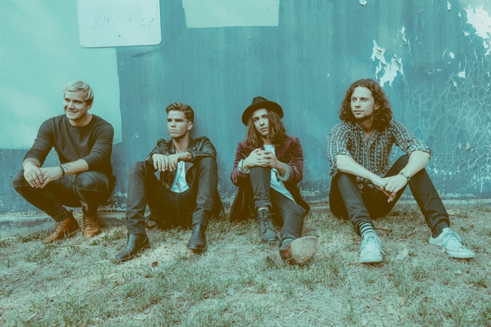 KALEO band sitting by a wall