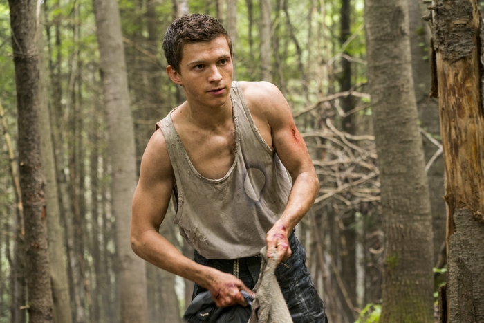 Tom Holland as Todd Hewitt in the woods
