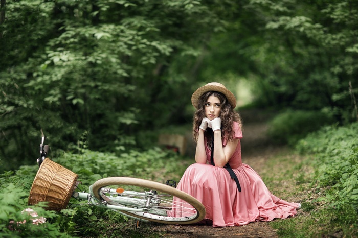 Young Woman in Pink Dress Sitting on Path