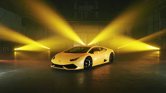 Yellow Lamborghini Huracan in spotlight