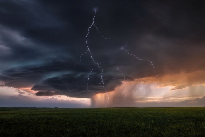 Dramatic lightning strikes over a stormy landscape