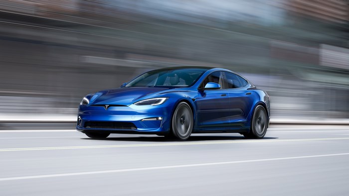 Blue 2021 Tesla Model S Plaid driving fast