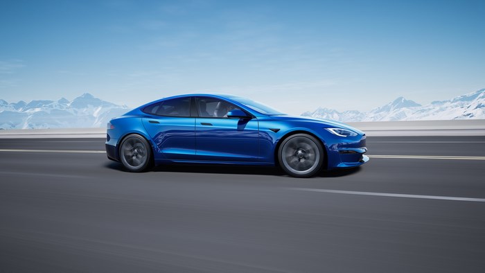 Blue 2021 Tesla Model S Plaid driving on a road