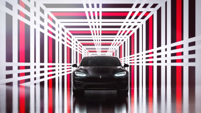 Black 2021 Tesla Model S Plaid in a Red and White Tunnel