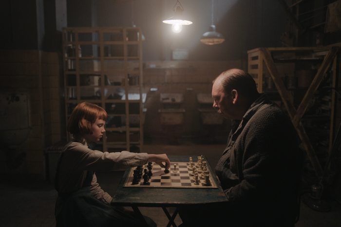 Beth Harmon and Bill Camp play chess