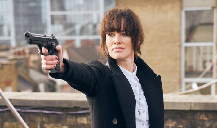 Lena Headey holding a gun