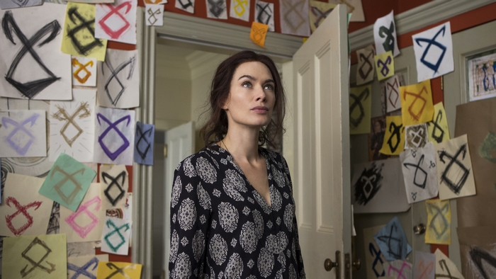 Lena Headey in a room with runes