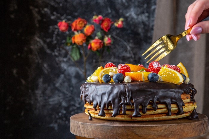 pancakes, blueberries, food, orange (fruit), raspberries, cutting board, flowers, sweets, cake, fork