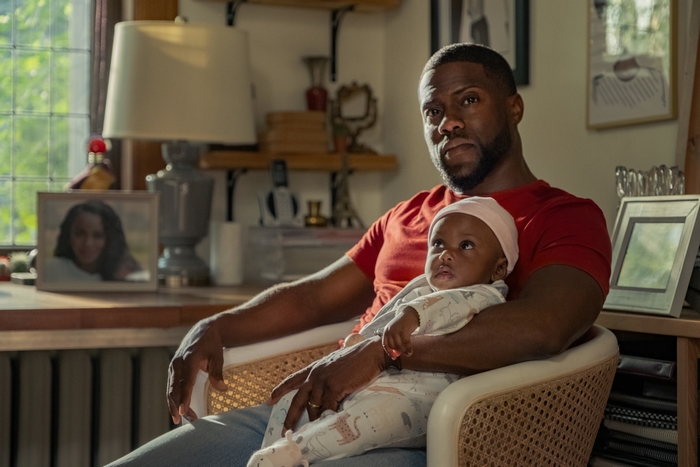 Kevin Hart holding his baby