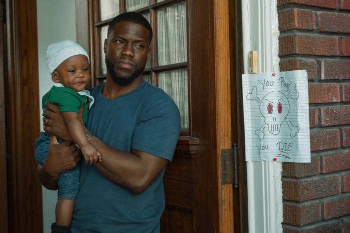 Kevin Hart holding a baby