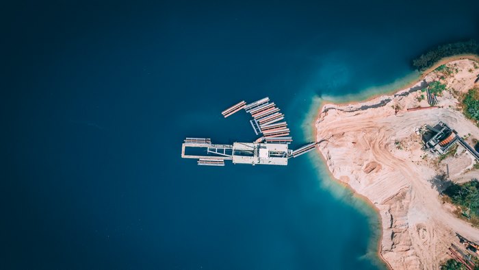 Aerial view of a dock and sandy coastline