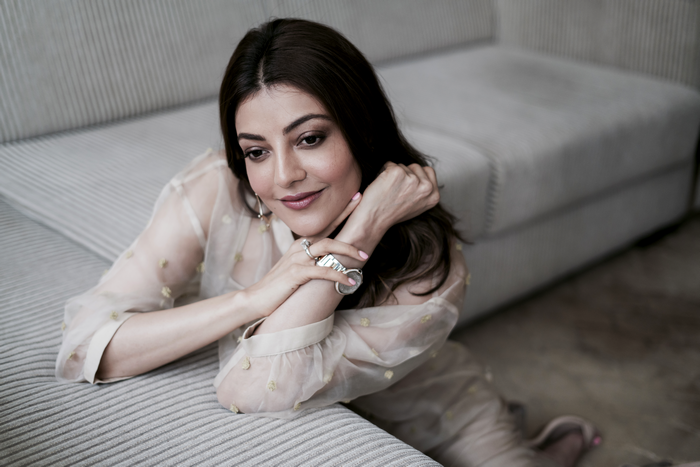 Kajal Aggarwal posing on a couch