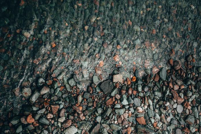 Close-up of wet stones on a riverbed