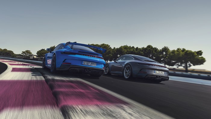 Two Porsche 911 GT3 cars on a race track