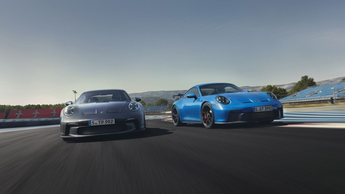 Two Porsche 911 GT3 cars on a race track