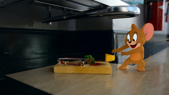 Jerry reaches for cheese on a mousetrap
