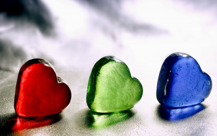 Three heart-shaped glass stones