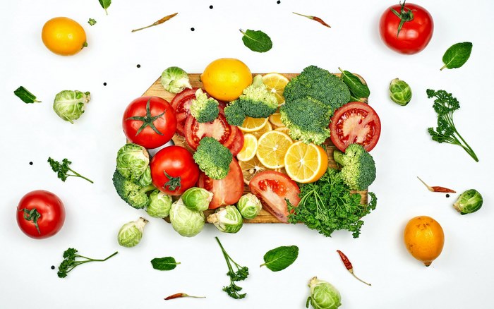 Fresh vegetables and fruits on a cutting board