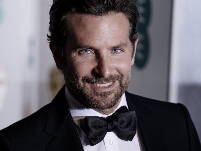Bradley Cooper smiling in a tuxedo