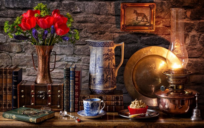 Still life with tulips, books, and oil lantern