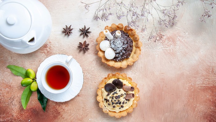 Tea and desserts with star anise and kumquats