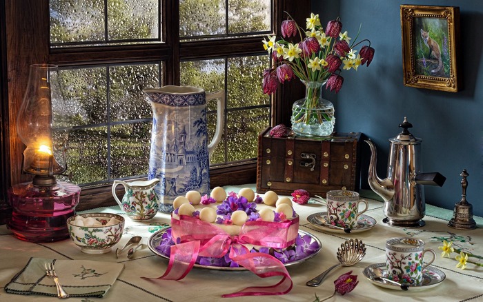 Still life with cake and flowers on a rainy day