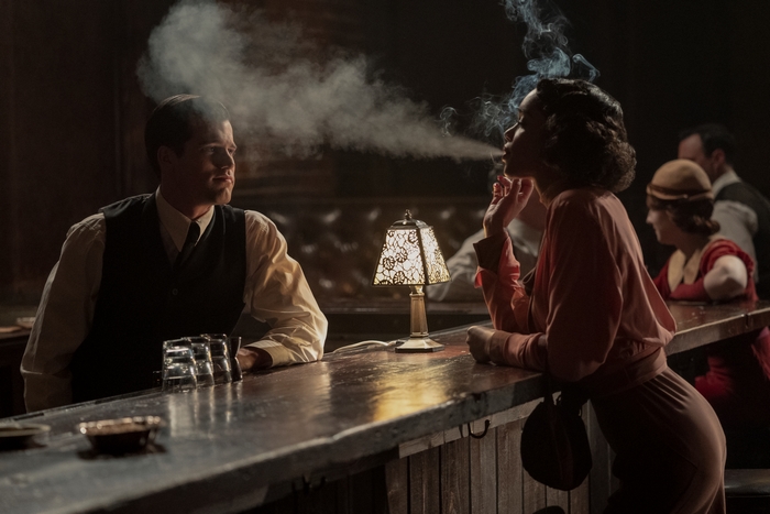Laura Harrier smoking at a bar
