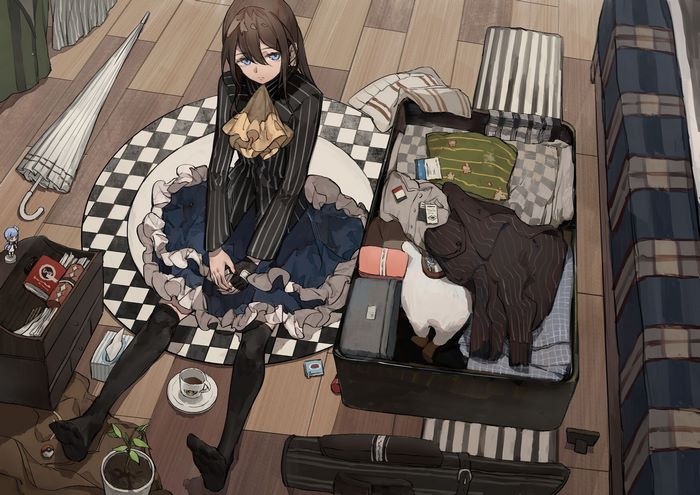 Girl with blue eyes and brown hair packing a suitcase
