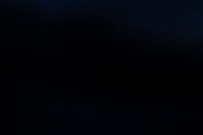 Abstract dark texture with subtle blue and white highlights