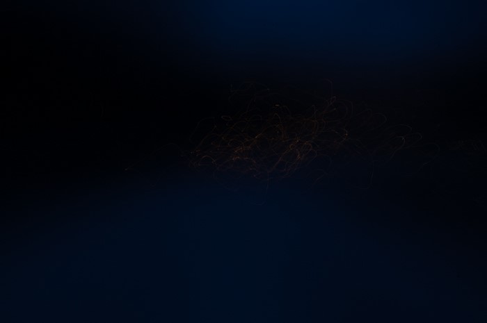 Abstract light trails in dark blue sky