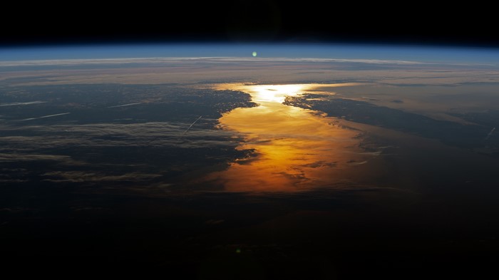 Sun reflecting on Earth's horizon from space