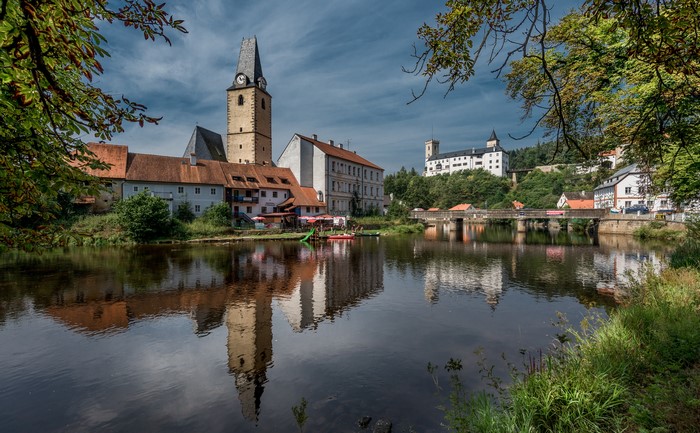 4K Rožmberk castle and church tower reflection in river