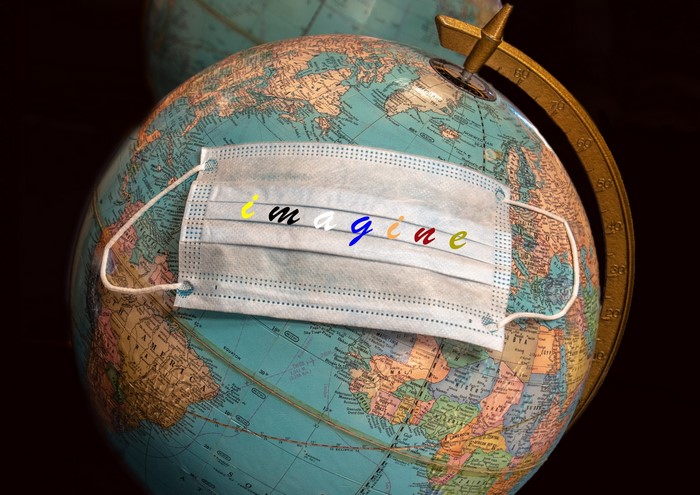 Globe with a face mask and the word imagine
