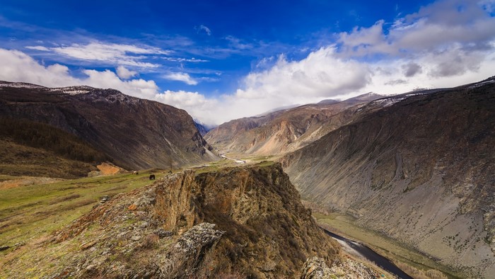 Mountain valley with river and clouds