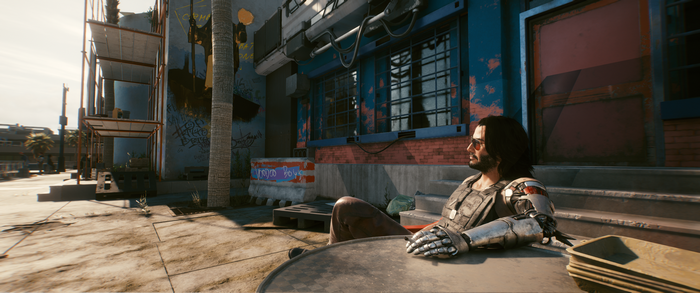 Johnny Silverhand from Cyberpunk 2077 sitting at a table