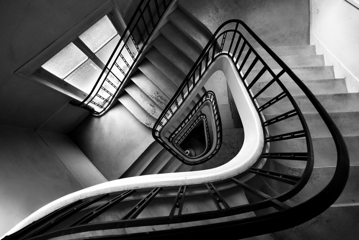 Monochrome top view of a spiral staircase with a window