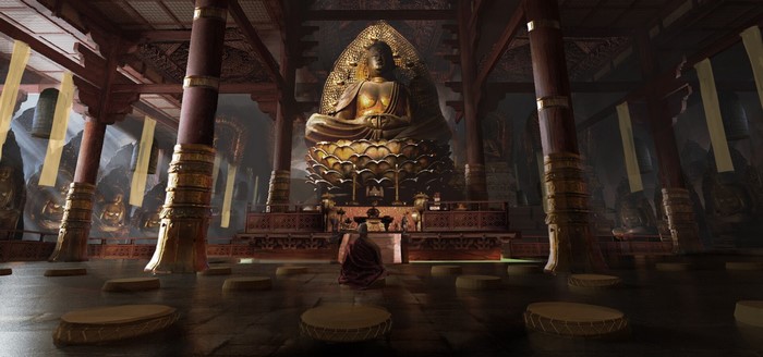 Monk meditating before a giant Buddha statue in a temple