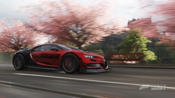 Bugatti Chiron driving past cherry blossoms near a castle in Forza Horizon 4