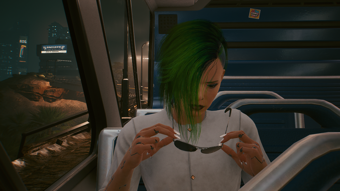 V from Cyberpunk 2077 holding sunglasses on a bus