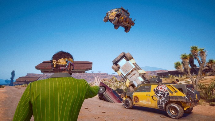 Man in green suit with hand gesture near crashed cars in Cyberpunk 2077