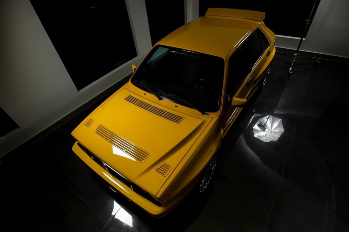 Yellow Lancia Delta Integrale in a studio