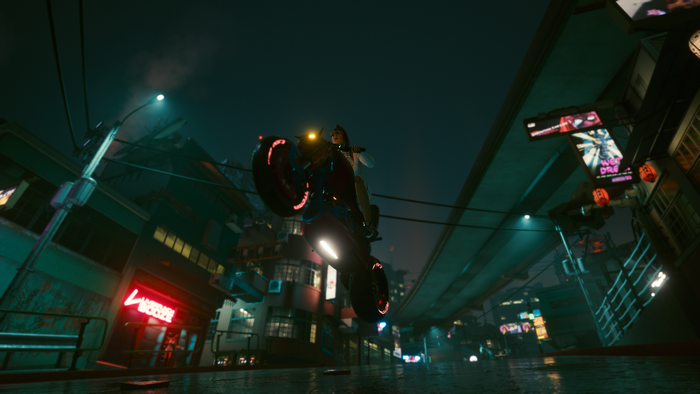 Female V riding a motorcycle in Cyberpunk 2077