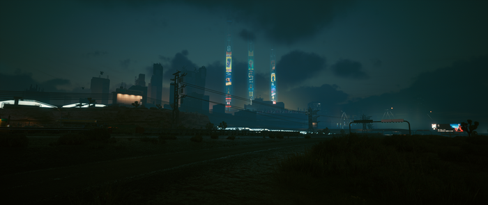 Cyberpunk 2077 cityscape at night with illuminated towers