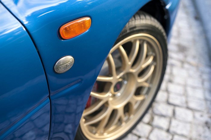 Blue Subaru 22B STI with gold wheels
