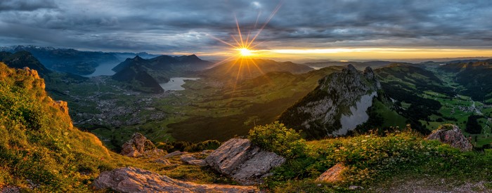 Sunrise over Swiss Alps landscape with lake and mountains