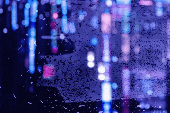 Abstract rain on glass with blurred city lights
