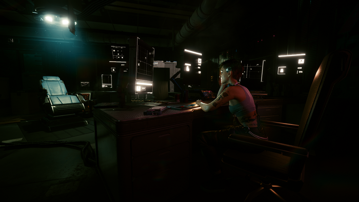 Woman working on computer in dark room