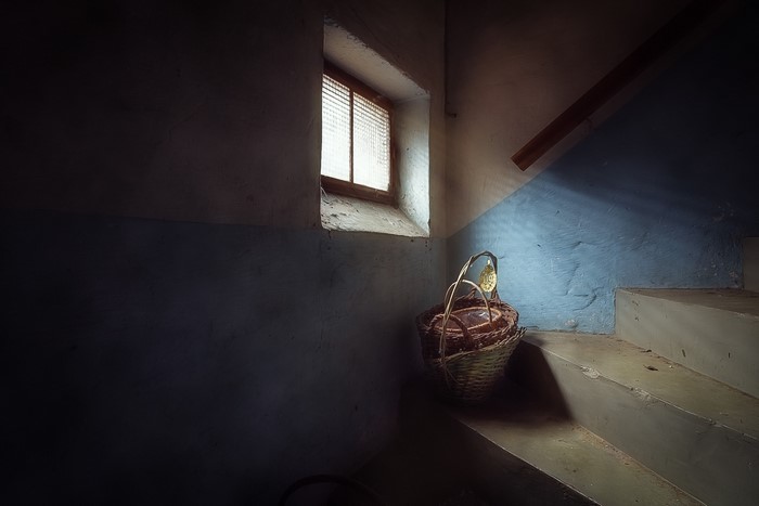 Basket on stairs near window