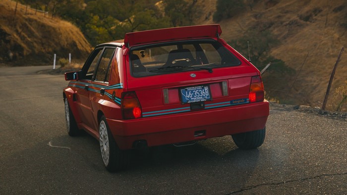 Red Lancia Delta Integrale on a winding road