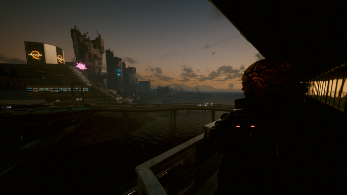 Cyberpunk 2077 screenshot of a futuristic city at dusk